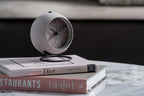 Karlsson wekker Nirvana Globe, donker warm grijs, sfeerfoto: op stapel boeken op marmeren tafel