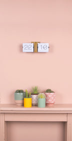 Karlsson flipklok Flip Clock No Case, wit met messing standaard, sfeerfoto: aan roze wand boven schouw met cactussen