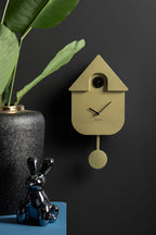 Karlsson koekoeksklok Modern Cuckoo, goud abs metallic, sfeerfoto: aan donkere muur naast plant en glanzend konijn