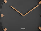 Karlsson wandklok Grace, zwart, detail: houten wijzers en houten streepjes op zwarte wijzerplaat, Karlsson-logo