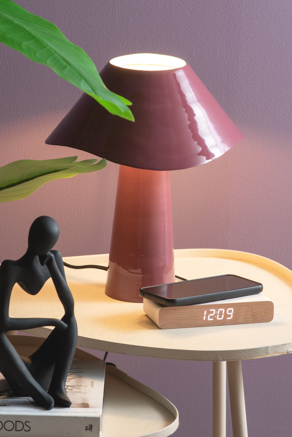Karlsson wekker Retro Flat LED, wit, sfeerfoto: op bijzettafel onder bordeaux lamp, telefoon ligt erop, display 12:09