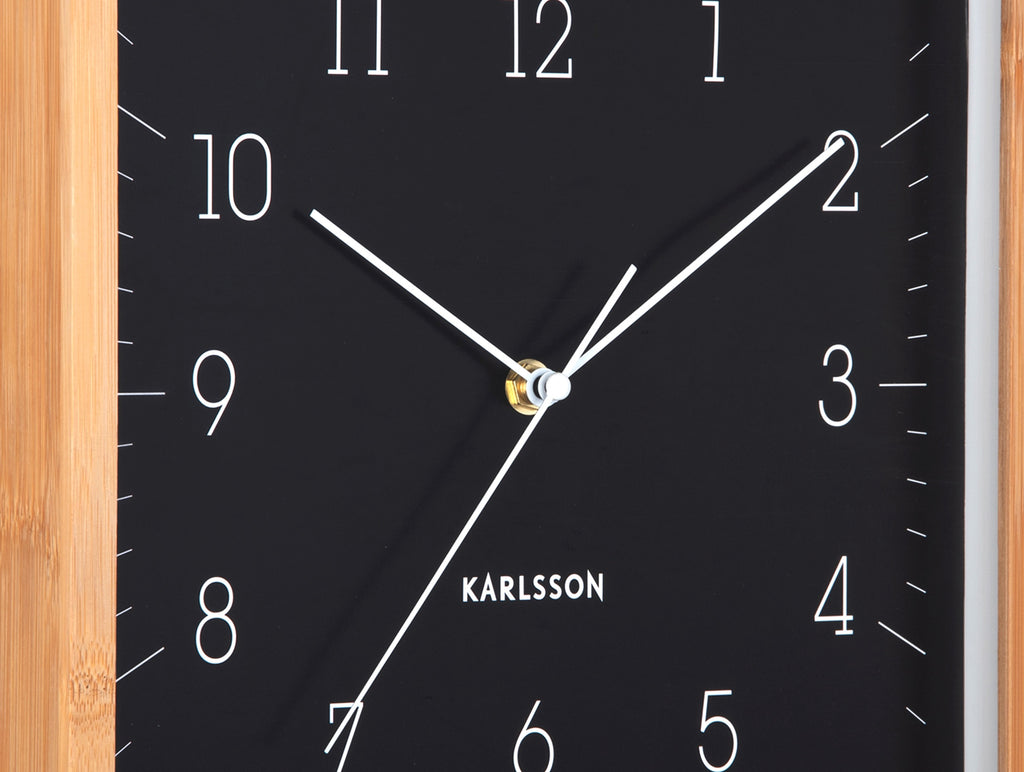 Karlsson wandklok Neat Cuadrado, zwart, detail: witte wijzers en cijfers, gouden middenpunt, Karlsson-logo