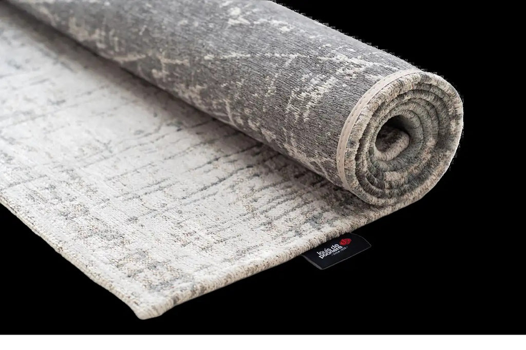 Louis de Poortere Mad Men Griff 8420 Jersey Stone vloerkleed met een plooi, dun en soepel