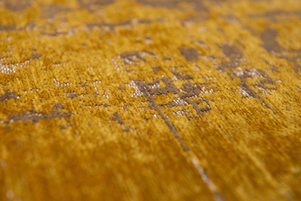 Close-up van het dessin van het Louis de Poortere Mad Men Griff 8550 Liberty Gold vloerkleed