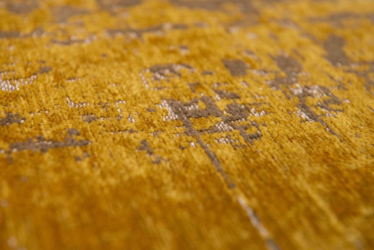 Close-up van het dessin van het Louis de Poortere Mad Men Griff 8550 Liberty Gold vloerkleed