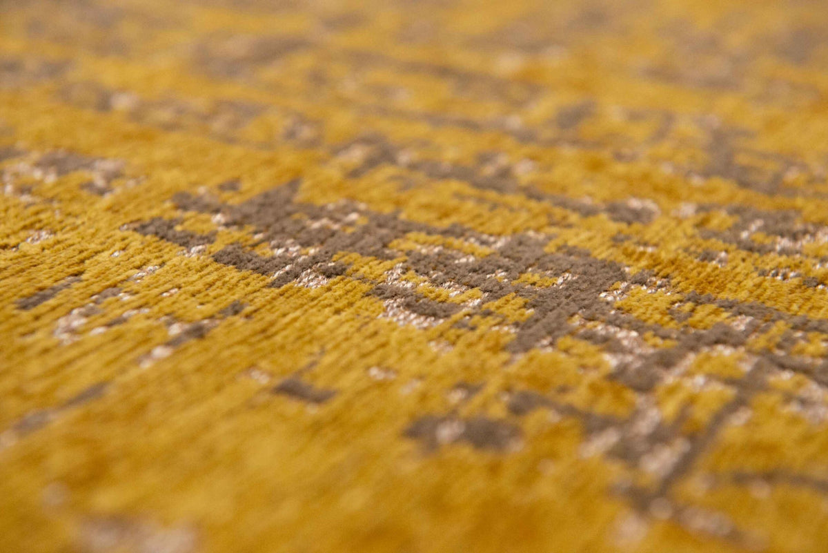 Close-up van het dessin van het Louis de Poortere Mad Men Griff 8550 Liberty Gold vloerkleed