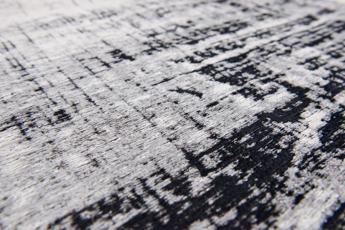 Close-up van het dessin van het Louis de Poortere Mad Men Griff 8926 Metro Black & White vloerkleed