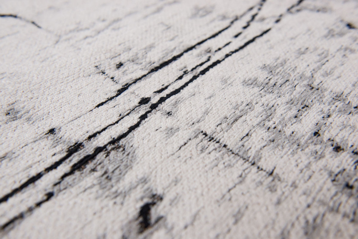 Close-up van het dessin van het Louis de Poortere Mad Men Griff 8926 Metro Black & White vloerkleed