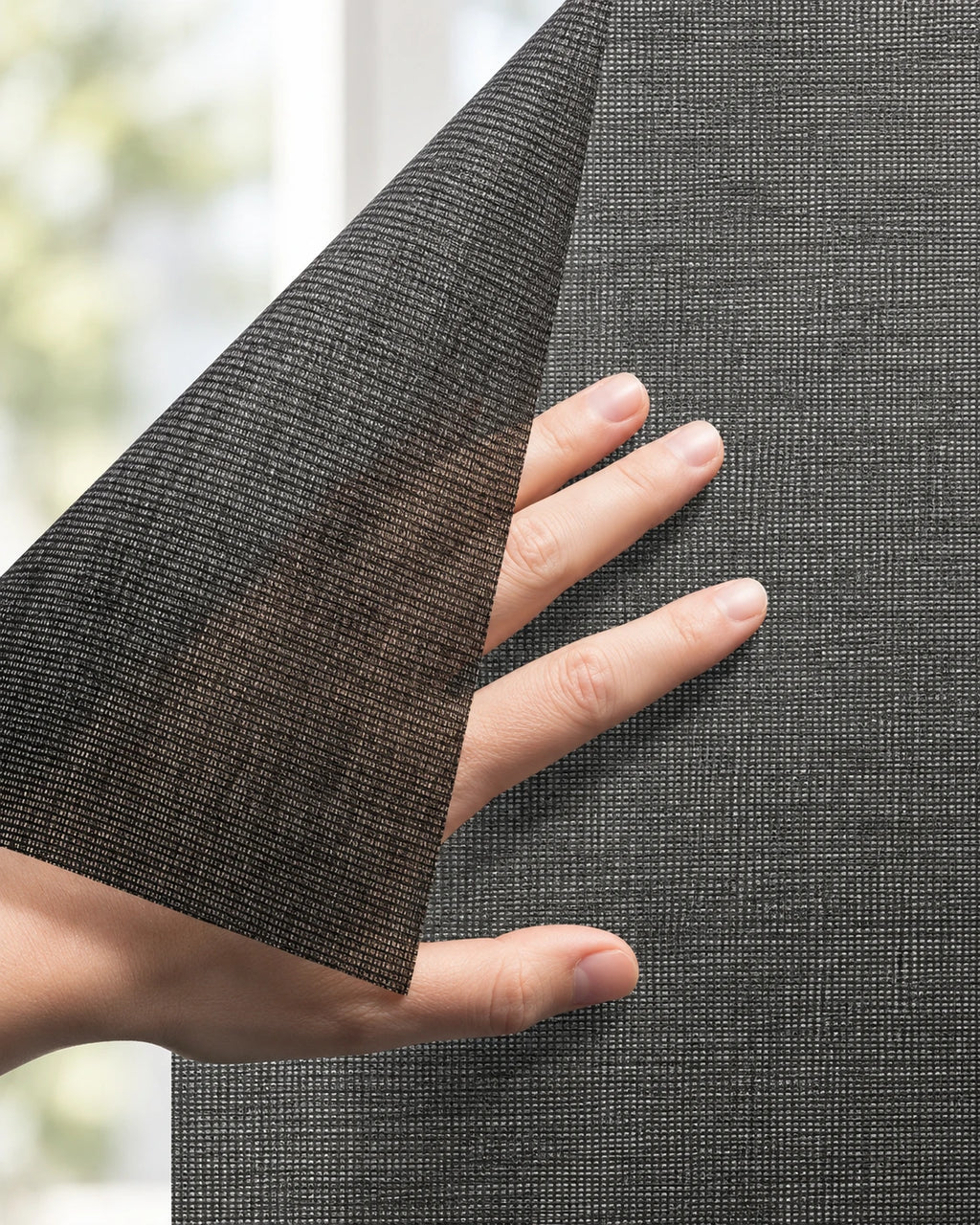 Squid raamtextiel op maat Coal - Zwart: hand tilt een hoek van het doorzichtige raamtextiel op voor een raam